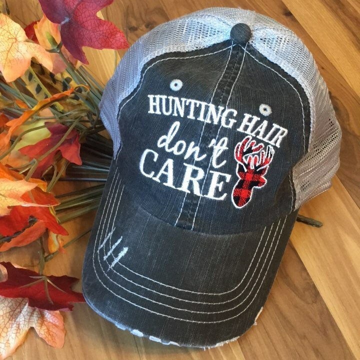 Hat { Hunting hair dont care } Gray with black and red buffalo plaid deer. Embroidered gray distressed trucker cap with adjustable Velcro and hole for pony. - Stacy's Pink Martini Boutique