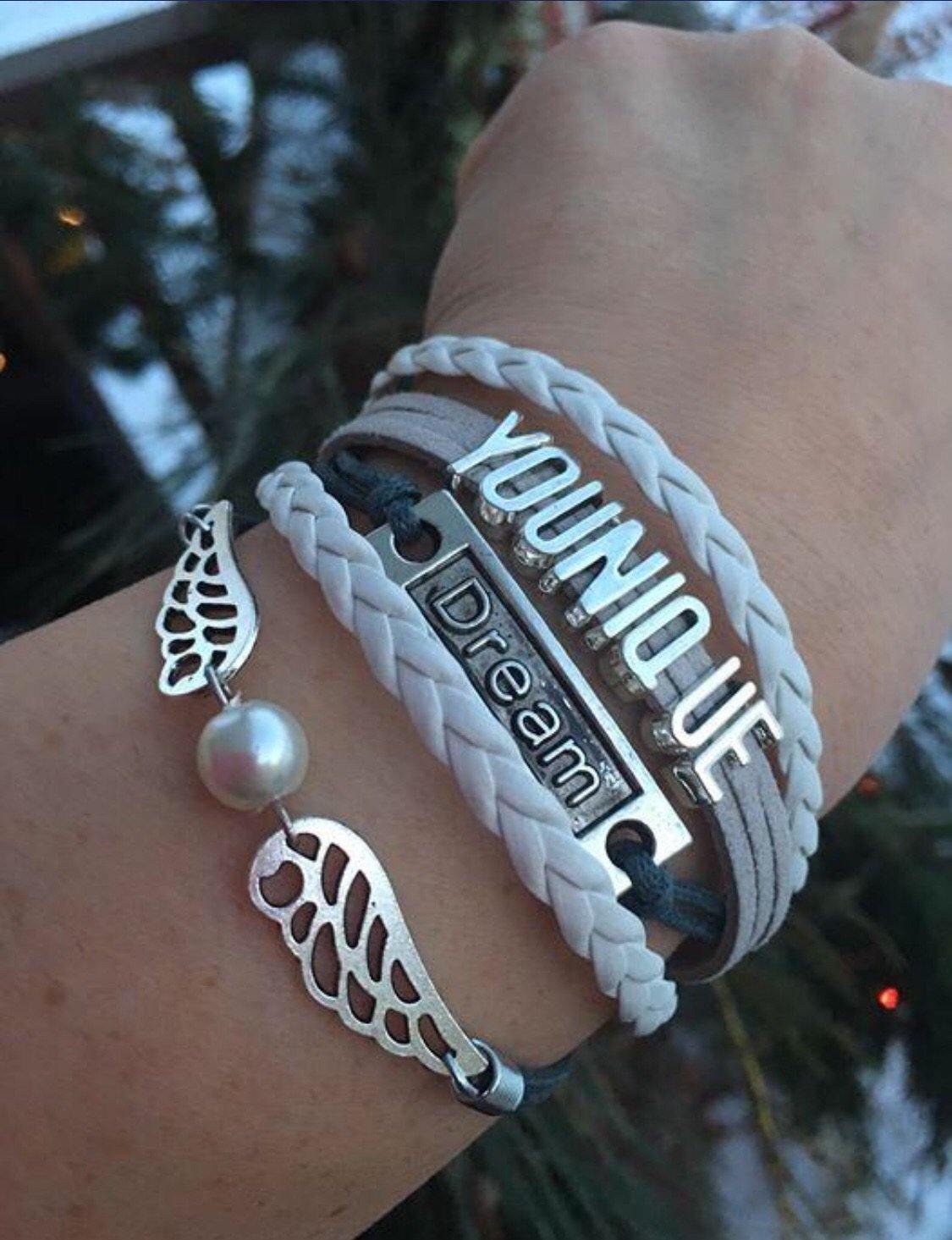 Bracelet { Younique } Wings. Dream. 1 grey/white. 1 purple/white. $5 - Stacy's Pink Martini Boutique