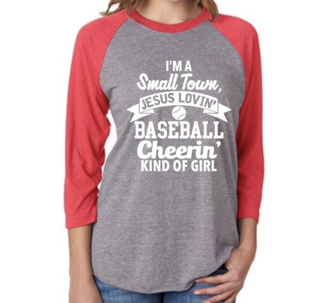 I’m a small town Jesus lovin baseball cheerin kind of girl shirt •• 3/4 sleeve raglan •• Red or black •• Women’s baseball clothing - Stacy's Pink Martini Boutique